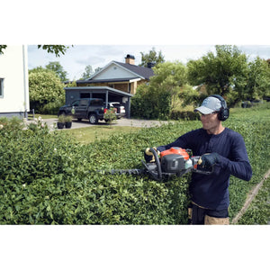 Person using hedge trimmer
