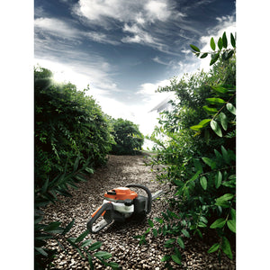Husqvarna 122HD45 Trimmer on path with hedgerow